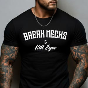 May include: Black crew neck t-shirt with the white text "BREAK NECKS & Kill Egos". The shirt is made of a soft material and is suitable for casual wear. The shirt is a great gift for anyone.