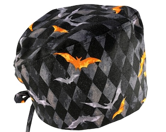 May include: Black and grey patterned surgical scrub hat with orange bats.