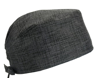 May include: A black scrub cap with a subtle textured pattern. The cap has a tie at the back.