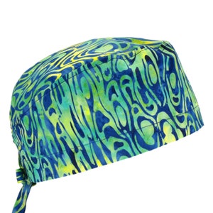 May include: A blue and green patterned surgical scrub hat with a tie. The pattern is a swirling, abstract design.