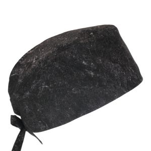 May include: A black scrub cap with a gray marble pattern. The cap has a tie at the back.