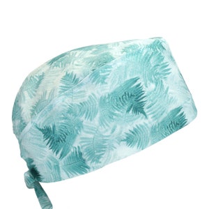 May include: A light blue surgical scrub cap with a fern leaf pattern.
