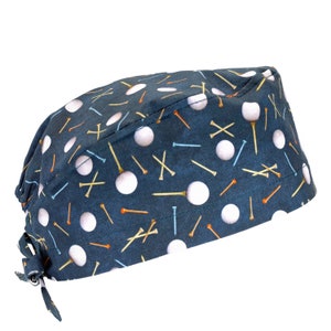 May include: A blue scrub hat with a white golf ball and tee pattern.