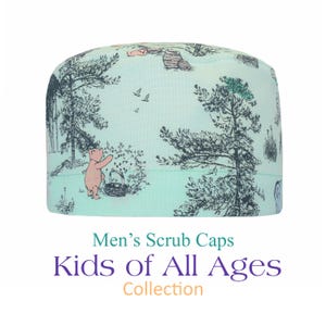 May include: A pale blue scrub cap with a forest design featuring a pink bear, trees, and a basket. The cap has the text "Men's Scrub Caps" and "Kids of All Ages Collection" in green, purple, and orange.