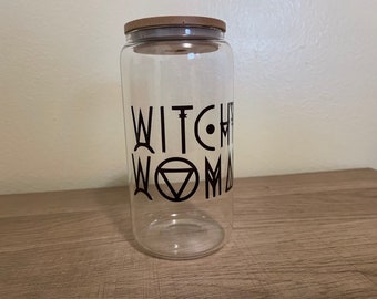 May include: A clear glass jar with a wooden lid and a black and white graphic that says "Witchy Woman".