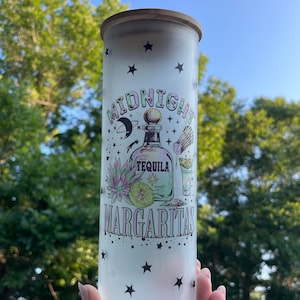 May include: A frosted glass jar with a wooden lid and a design that says "Midnight Margaritas" with a tequila bottle, lime, and a margarita glass. The design also includes stars and a crescent moon.