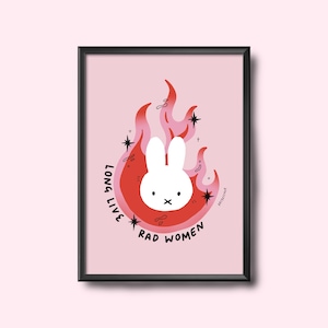 May include: Framed art print with a white bunny head in a red and pink flame design. The text "LONG LIVE RAD WOMEN" is in a circular pattern around the flame. The background is a solid light pink.