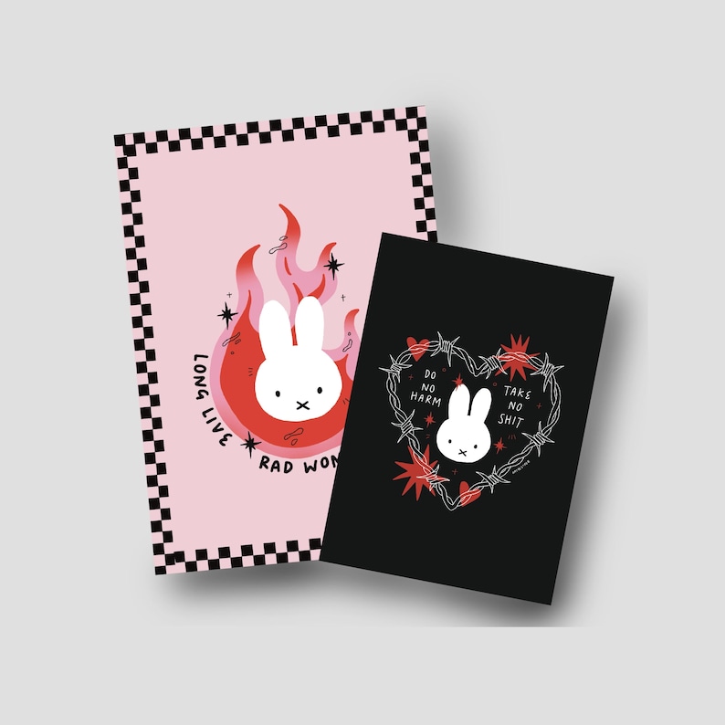 May include: Two art prints with a white bunny illustration. One is pink with a bunny in flames and the text "Long Live Rad Won". The other is black with a bunny inside a barbed wire heart and the text "Do No Harm Take No Shit".