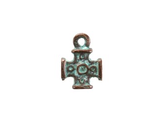 May include: A small, bronze-colored cross pendant with a turquoise patina. The cross has a detailed design with a circular center and four arms, each with a rectangular extension. A loop is at the top for hanging.