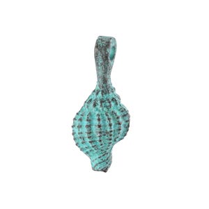 May include: A turquoise seashell pendant with a textured surface and a loop for hanging. The pendant has dark brown accents and a weathered appearance, suggesting an antique or vintage style.