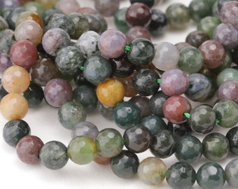 May include: A strand of multi-colored agate beads with a faceted finish. The beads are round and have a variety of green, brown, yellow, and purple hues.