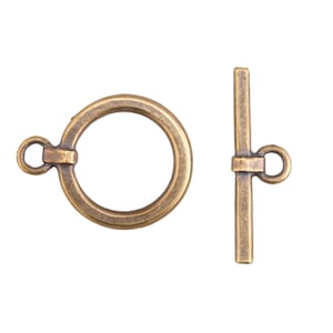 May include: Antique brass toggle clasp set. The set includes a circular ring and a straight bar with a small loop on each piece. The clasp is designed for jewelry making and crafting. The metal has a warm, aged appearance.