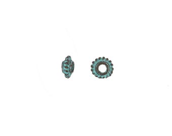 May include: Two small, round beads with a distressed, aged appearance. The beads have a teal and brown color scheme, with a textured, floral-like design around the edges. One bead is viewed from the side, and the other is viewed from the top.