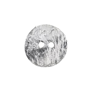 May include: A silver-colored button with a textured, irregular surface. The button is round with two holes for sewing. The button's design gives it a unique, handcrafted appearance, suitable for various sewing projects.