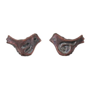 May include: Two copper-colored bird-shaped ornaments. Each bird has a stylized design with a round eye and a spiral or curved pattern on the body. The ornaments are likely for decoration or jewelry.