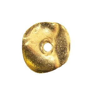 May include: A gold-colored, disc-shaped earring back with a textured surface and a central hole. The earring back is round with a slightly irregular shape, and is set against a white background.