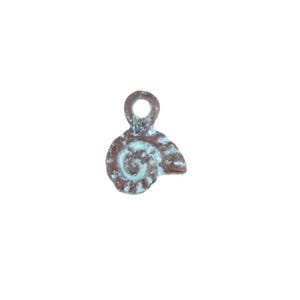 May include: A small, bronze-colored charm with a spiral design and a loop at the top. The charm has a distressed, weathered appearance with hints of turquoise-blue patina, suggesting an antique or vintage aesthetic.