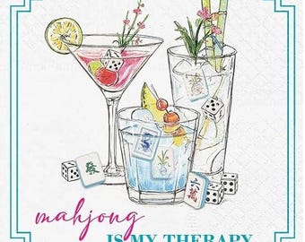 May include: Illustration of three cocktails with garnishes, dice, and Mahjong tiles. The text "mahjong IS MY THERAPY" is written in pink script. The image has a teal border.