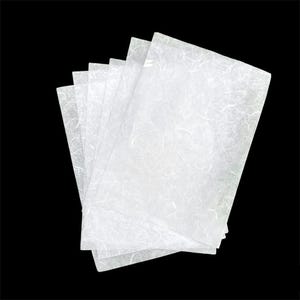 May include: A stack of white tissue paper sheets with a textured, crinkled surface.