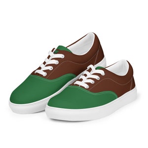 May include: A pair of low-top canvas sneakers with a brown and green color scheme. The shoes have white laces and a white sole.