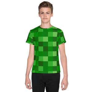 May include: A green and light green checkered pattern short-sleeved t-shirt for kids.