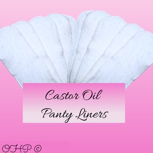 May include: A stack of white cotton castor oil panty liners. The liners are folded in a fan shape and have a white stitched edge.
