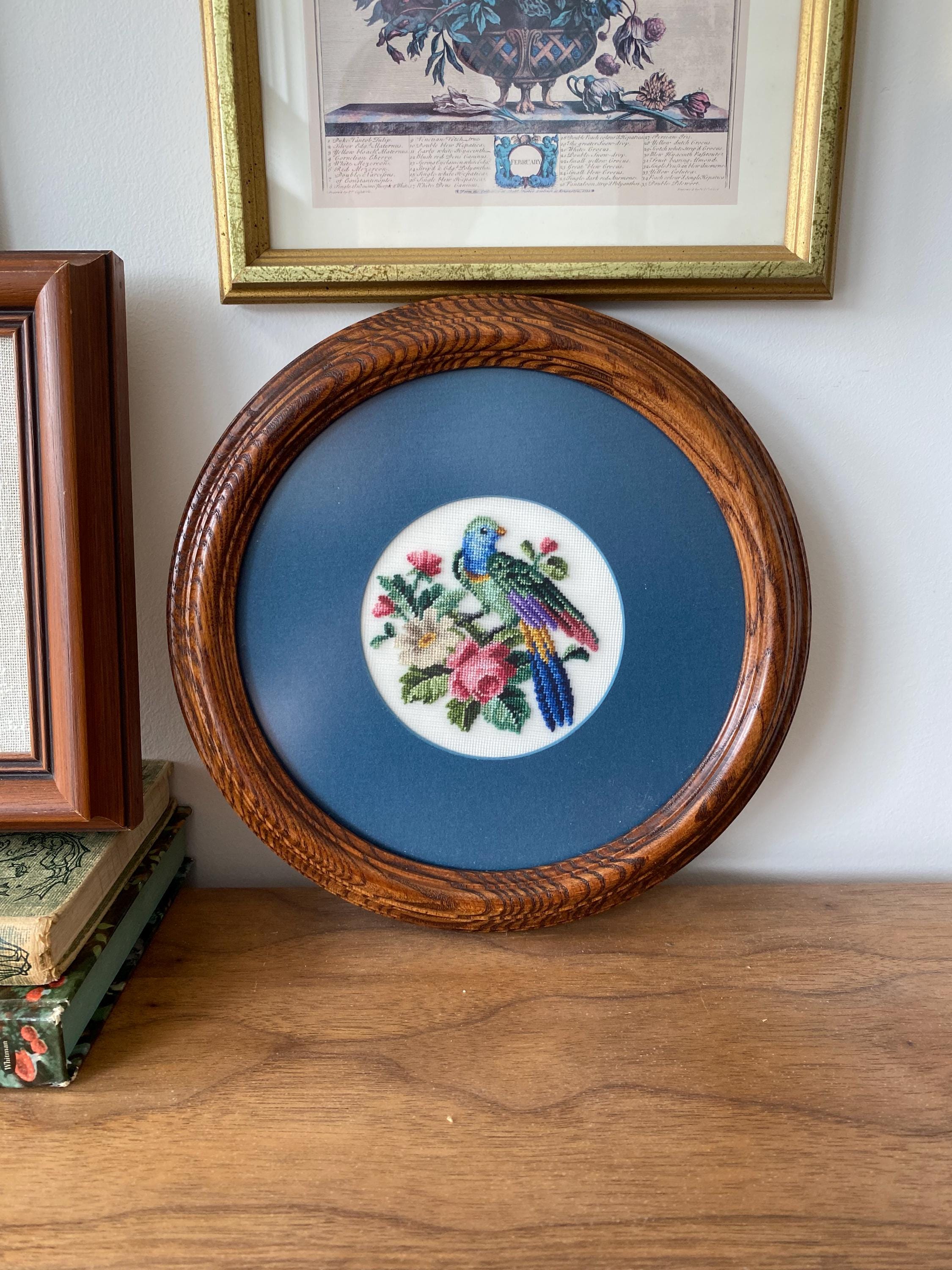 Vintage Framed Needlepoint Bird Art – Embroidered Bird with Flowers – Round Wood Frame – Cottagecore Wall Decor – Hand-Stitched Textile Art