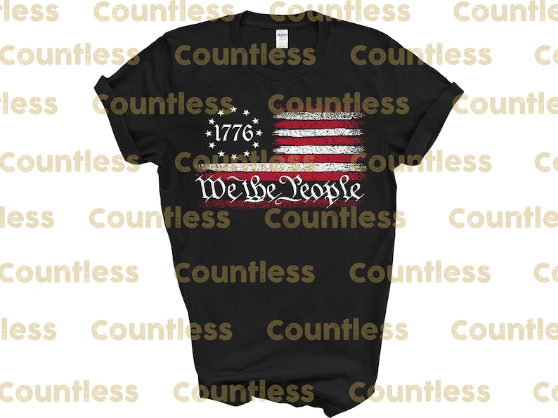 May include: Black t-shirt featuring a distressed American flag design with the text "We the People" in white. The flag has 13 red and white stripes and 13 white stars in a blue circle with the year "1776" in the centre.