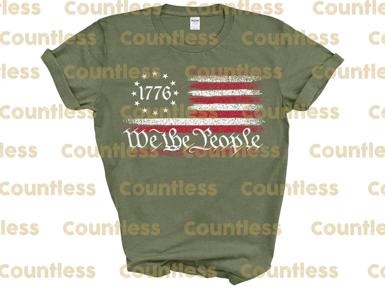 May include: A green t-shirt featuring a distressed American flag design with the text "We the People" and "1776" printed on it.