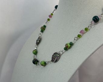 Porcelain floral and crystals matinee length necklace with 3 inch extension.