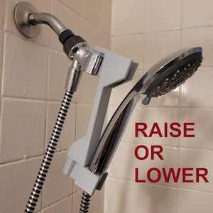 Innovative Shower head height adjuster to raise or lower your showerhead in three settings. 3D printed with Grey PETG plastic. No Plumbing