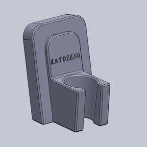 May include: A gray 3D-printed holder with the text "KAYDEE3D" on the front. The holder has a rectangular back and a curved opening at the bottom, designed to hold a cylindrical object. The design is simple and functional.