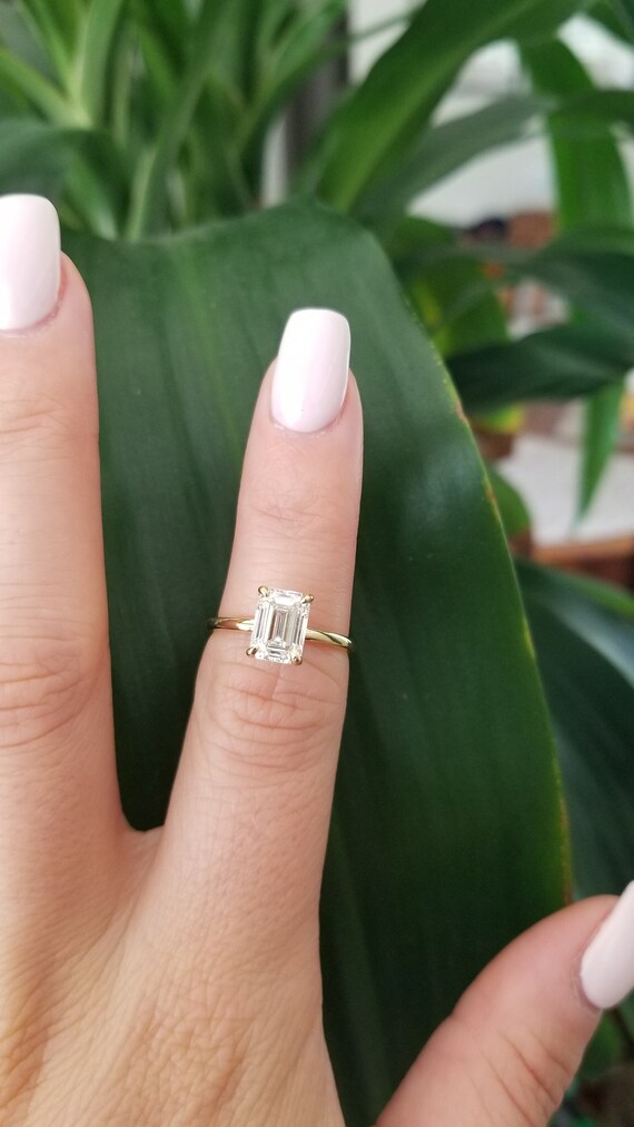 1.7 carat emerald cut diamond on hand deals