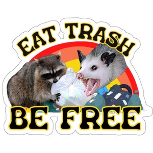 May include: A sticker with a raccoon and an opossum eating trash. The sticker has a rainbow background and the text "Eat Trash Be Free" in black letters.