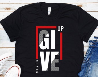 May include: Black t-shirt with a white graphic that says "NEVER GIVE UP" in a bold, red-outlined box.