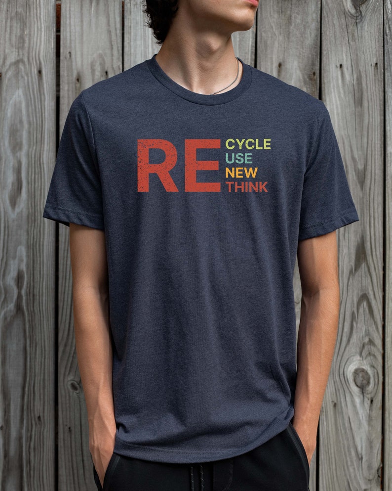 May include: A dark blue t-shirt with the word "RE" in red and the words "CYCLE USE NEW THINK" stacked vertically in colorful text.