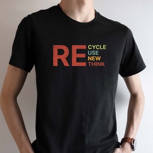 May include: A black t-shirt with the word "RE" in red, followed by the words "CYCLE", "USE", "NEW", and "THINK" stacked vertically in different colors.