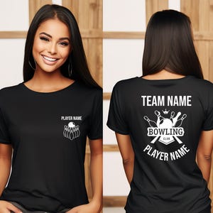 May include: Black t-shirt with a white bowling graphic on the front and back. The front features a bowling pin and ball design with the text "PLAYER NAME". The back displays "TEAM NAME", "BOWLING CLUB", and "PLAYER NAME".