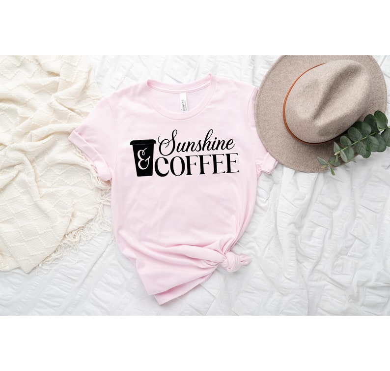 May include: Pink t-shirt with a black graphic of a coffee cup and the text "Sunshine & COFFEE".