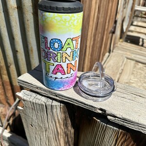May include: A white stainless steel tumbler with a black lid and a colorful graphic that says "Float Drink Tan Repeat".