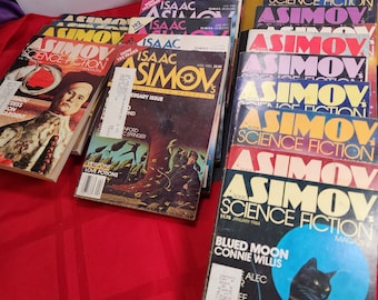 May include: A stack of vintage science fiction magazines featuring the iconic Isaac Asimov's Science Fiction Magazine covers. The covers feature various illustrations and titles, including "Love Potions" and "Blued Moon".