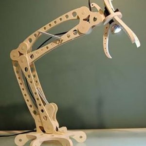 May include: A wooden desk lamp with a unique articulated arm design. The lamp has a light bulb at the end of the arm and a base with multiple legs.
