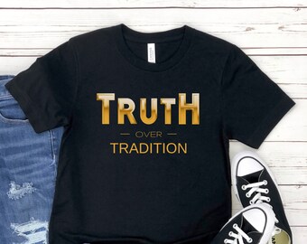 May include: Black t-shirt with gold text that reads "TRUTH OVER TRADITION".