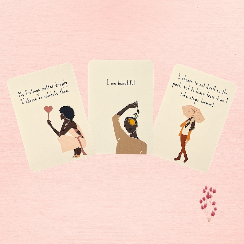 May include: Three affirmation cards with illustrations of people and text. The first card says "My feelings matter deeply. I choose to validate them." The second card says "I am beautiful." The third card says "I choose to not dwell on the past, but to learn from it as I take steps forward."