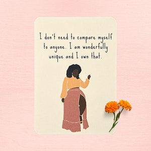 May include: A beige card with a black and brown illustration of a woman with a quote that reads "I don't need to compare myself to anyone. I am wonderfully unique and I own that."