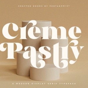 May include: White text on a brown background reads "Crème Pastry" in a stylized font. The text is layered on top of three stacked cylindrical platforms.