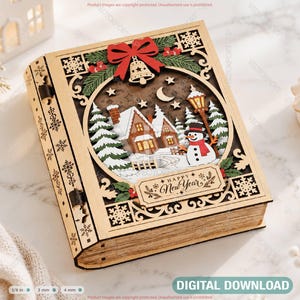 May include: A laser-cut wooden book-shaped box featuring a layered winter scene with a house, snowman, and streetlamp. The cover displays a red bow, a bell, and the text Happy New Year. The side panels show snowflake cutouts and metal hinges.