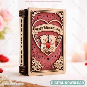 May include: A wooden Valentine's Day box with a heart-shaped design. The box features two teddy bears holding a heart, with the text "Happy Valentine's Day" on a banner. The box is decorated with floral accents and the word "LOVE" on the side.