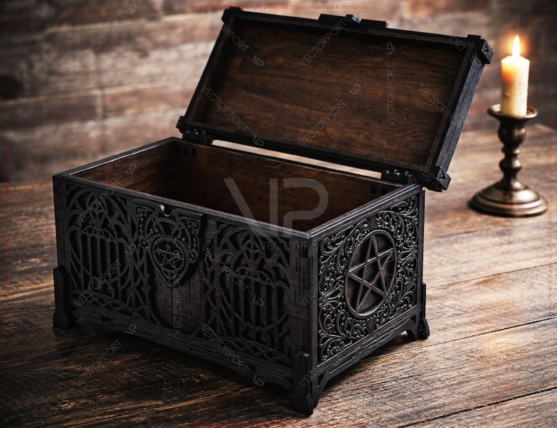 May include: An open, black wooden chest with intricate gothic carvings and a pentagram design on the front. The interior is dark brown. A lit candle in a brass holder sits to the right, on a wooden surface.