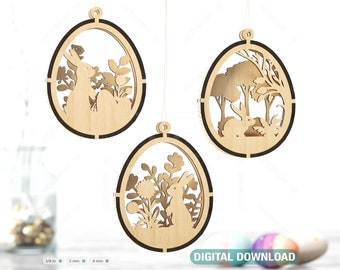 Pode incluir: Três enfeites de ovo de Páscoa de madeira com designs cortados a laser. Cada ovo apresenta uma cena diferente: um coelho num jardim, um coelho numa floresta e um coelho entre flores. Perfeitos para a decoração de Páscoa.